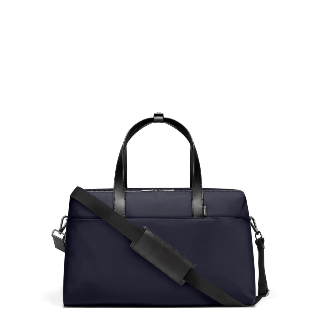 5. Away The Everywhere Bag black personal item bag, handle up, from the side