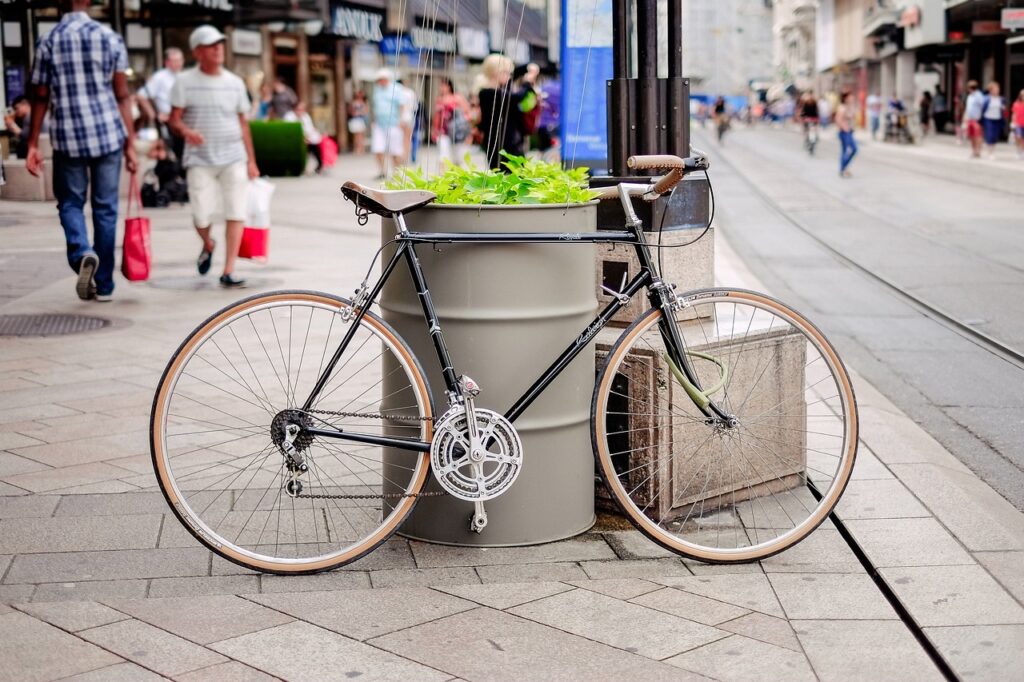 Bicycle leaning up against a drum in the middle of the sidewalk, from StockSnap from Pixabay