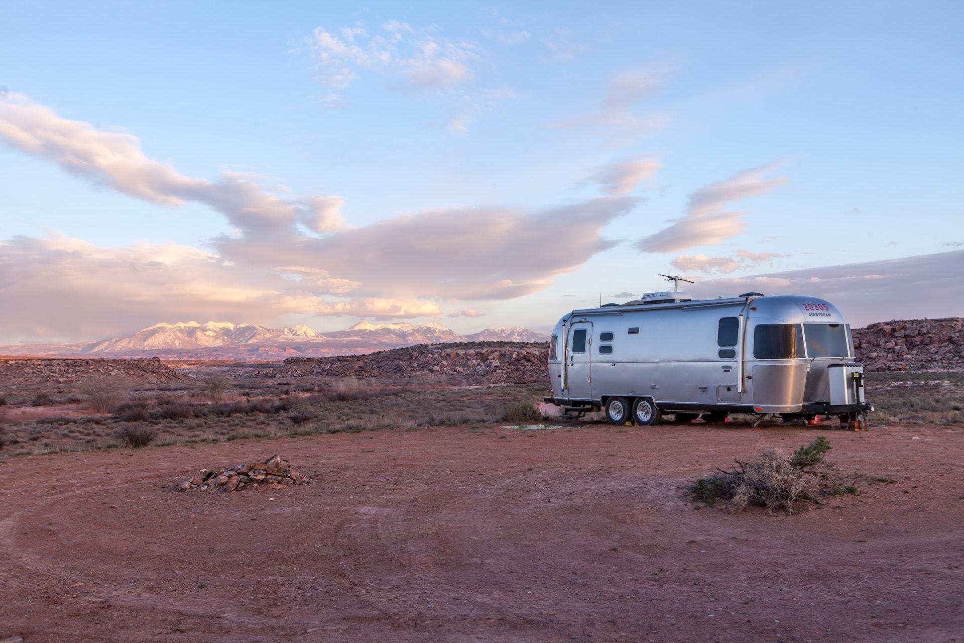 Airstream travel trailer in the middle of a camping grounds, making it one of the Best Travel Trailer Brands